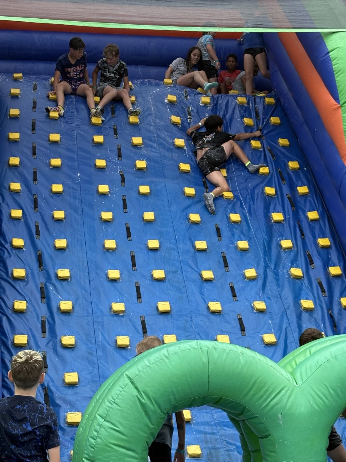 Guests climbing a giant inflatable wall