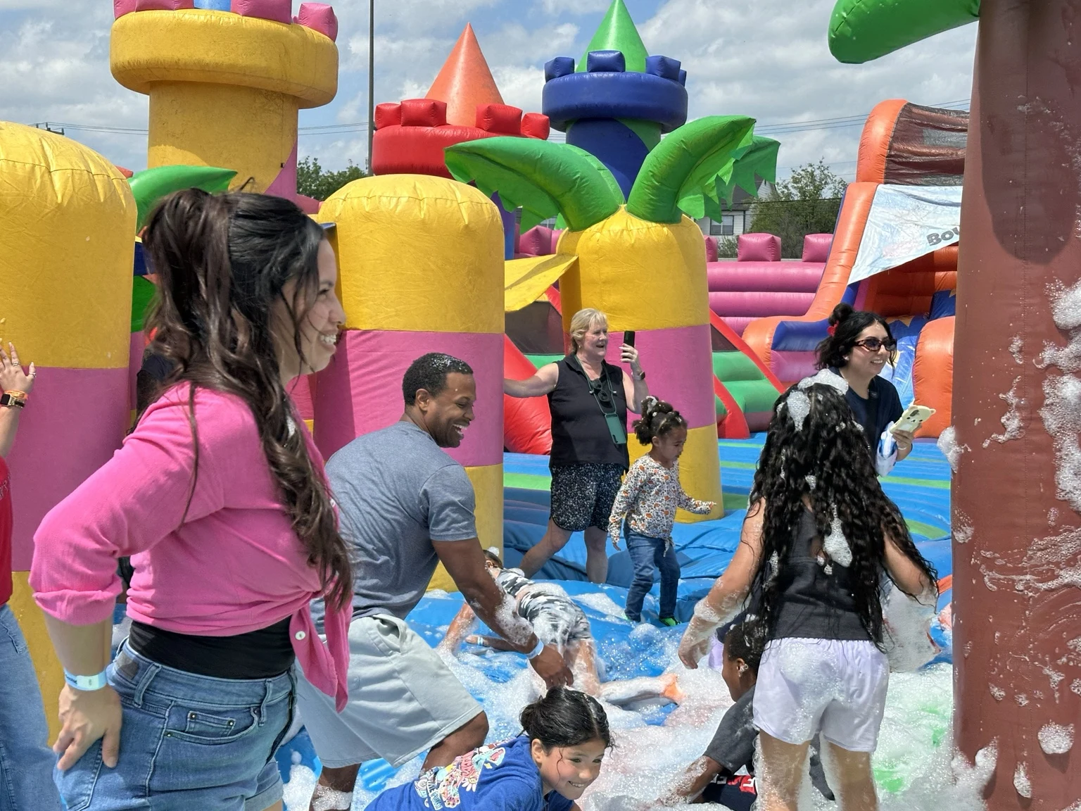 Families playing among colorful inflatables